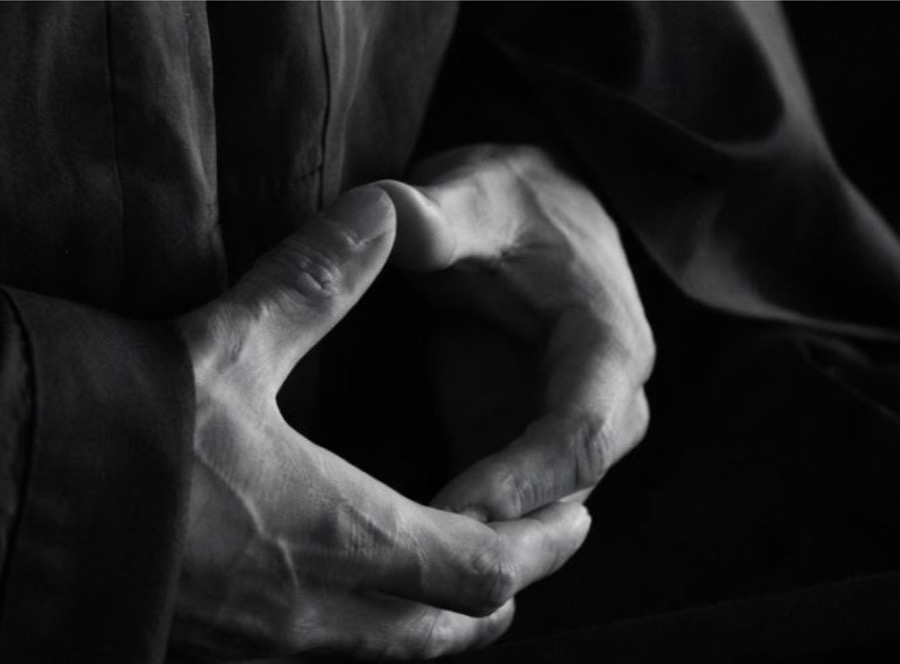 Hands resting in the zazen meditation mudra